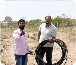 Team carrying irrigation pipes for plantation setup